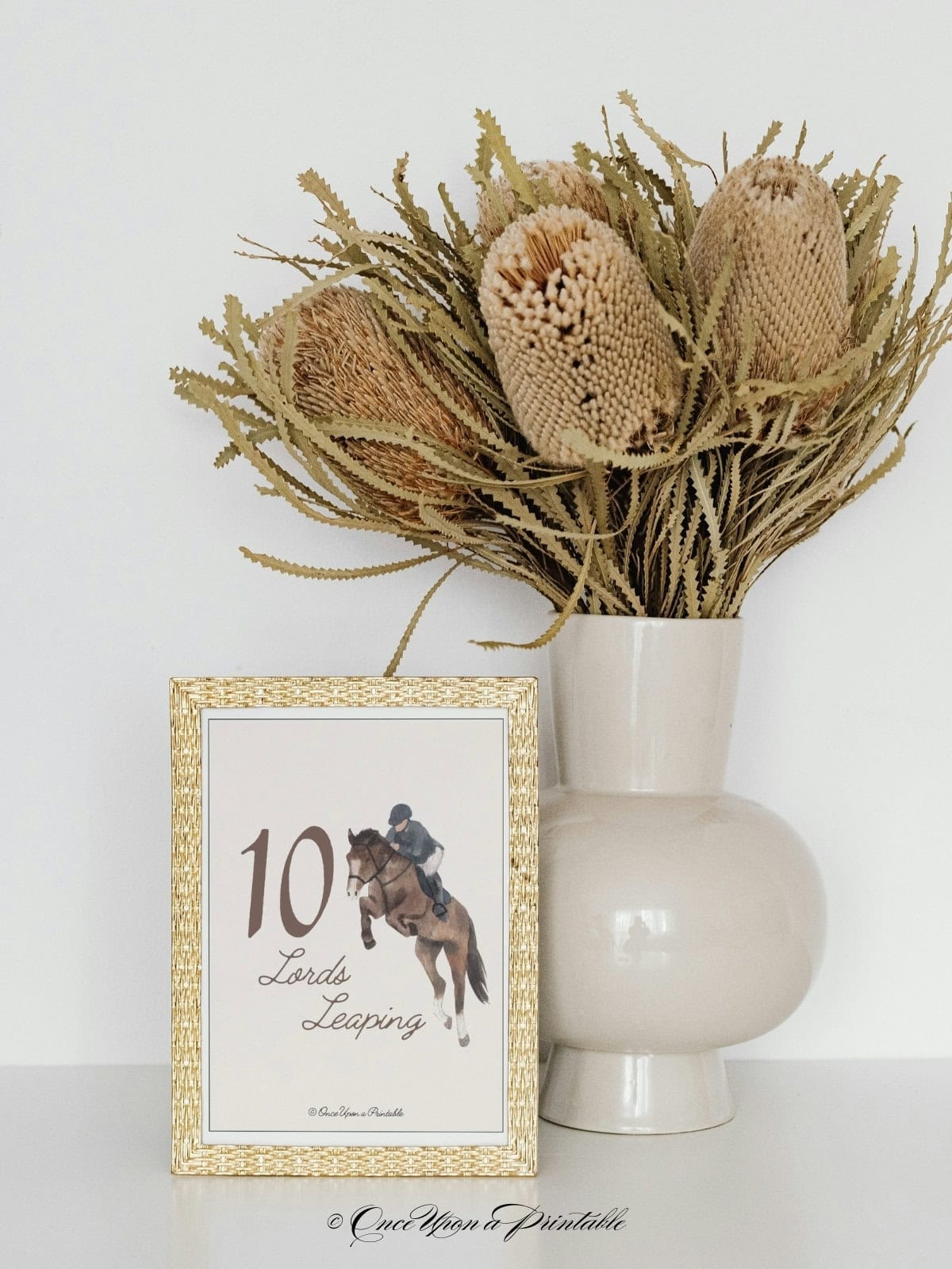 A small watercolor print of the 10 lords leaping graphic of a man on a horse jumping.