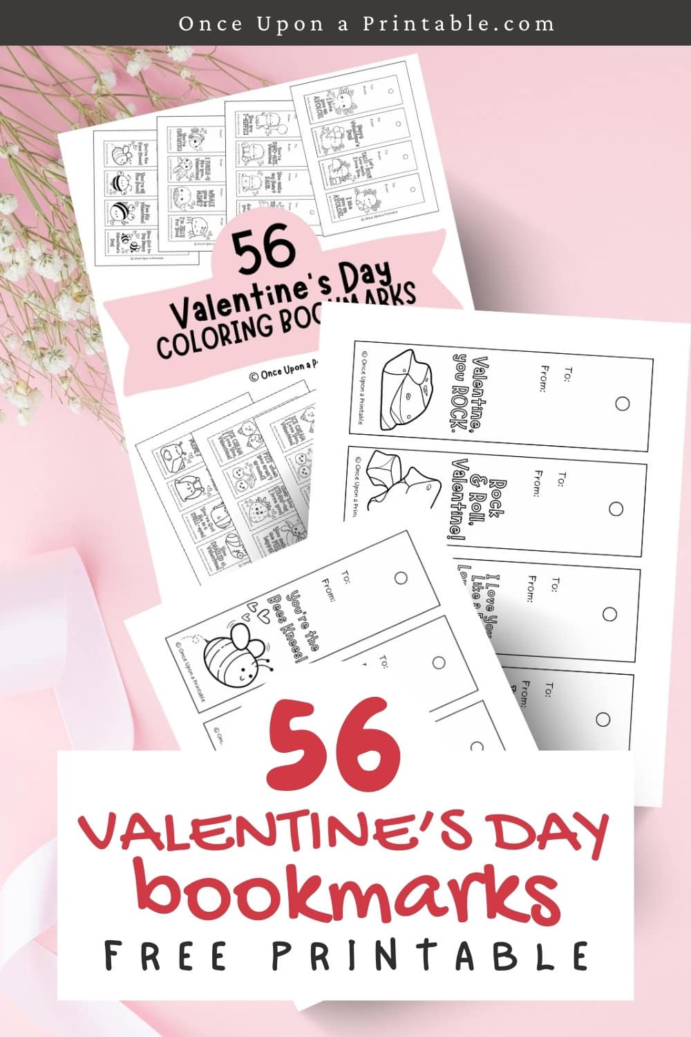 Kid's coloring bookmarks for Valentine's Day laying on a pink background with ribbons and baby's breath flowers.