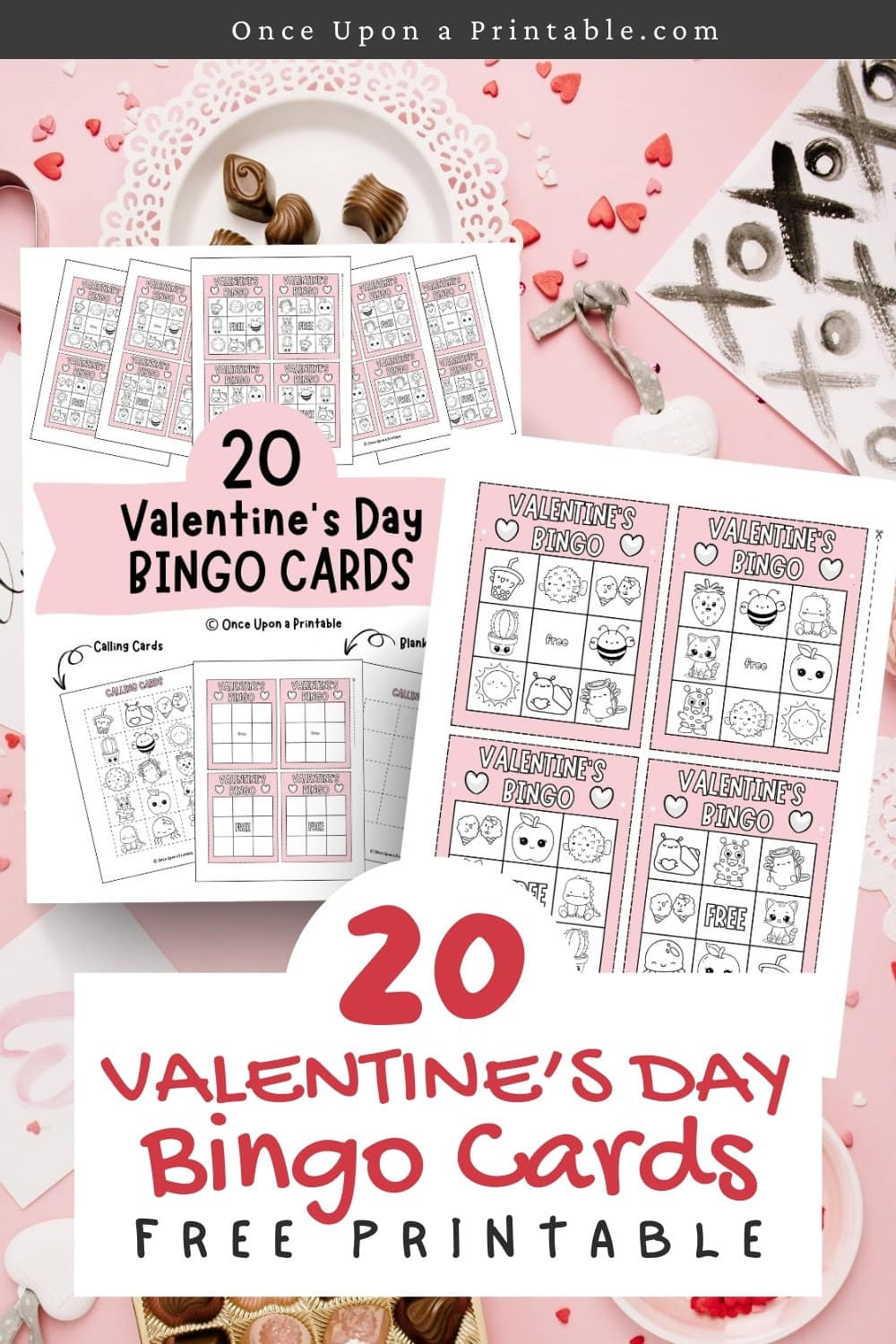 Valentine's Day Bingo cards to color laying on a cluttered candy surface.