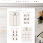 Anne of Green gables tic tac toe card with anne shirley and gilbert blythe, laying on a table with a pen and paper.