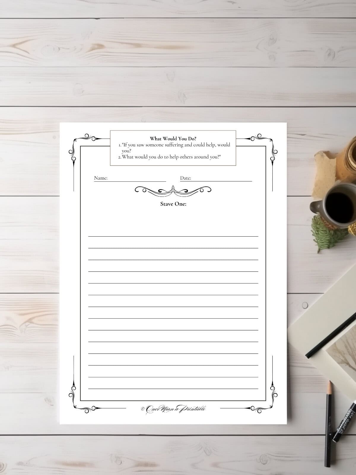 A Christmas Carol companion writing prompt page laying on a table top with pencils and a cup of tea.