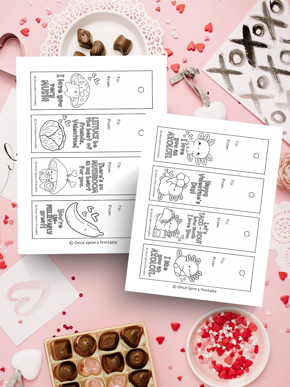 Coloring bookmarks for valentine's day laying on a chaotic candy background.