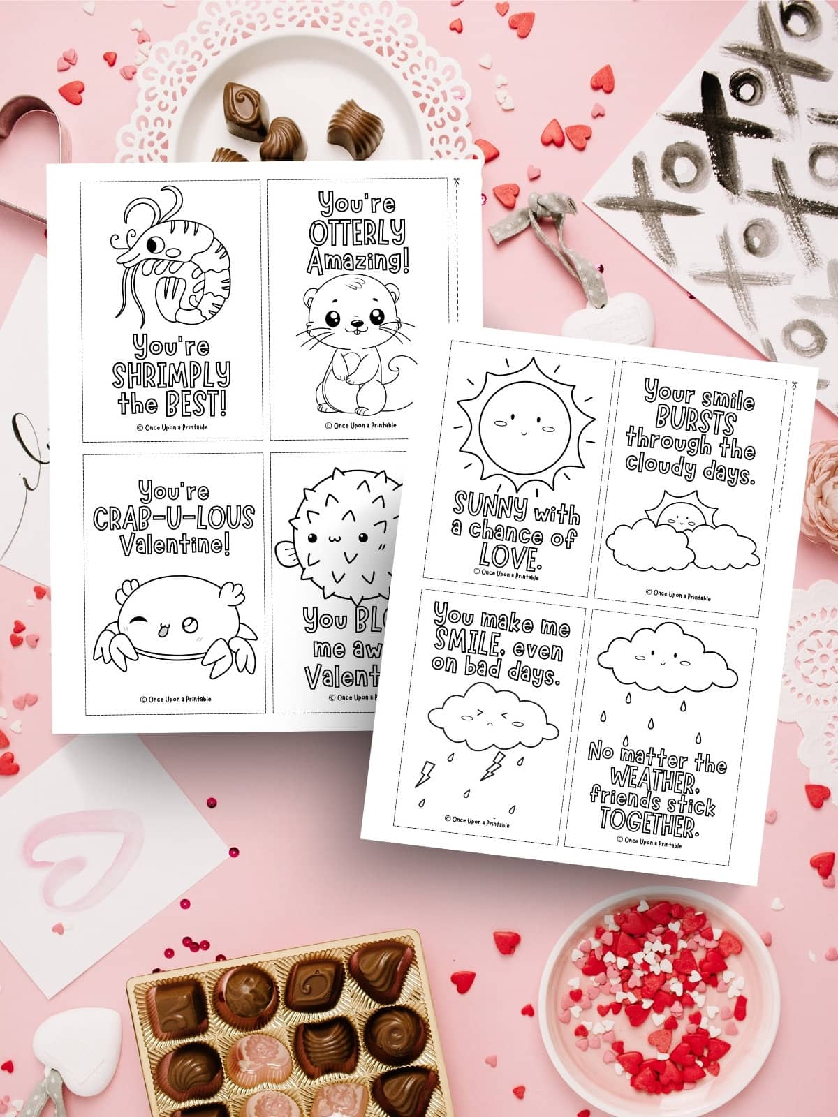 Cute Kawaii style graphics on Valentine's day coloring cards for kids laying on a messy candy background.