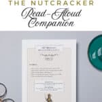 The nutcracker companion guide printed and laying on a table top with glasses and a cup.