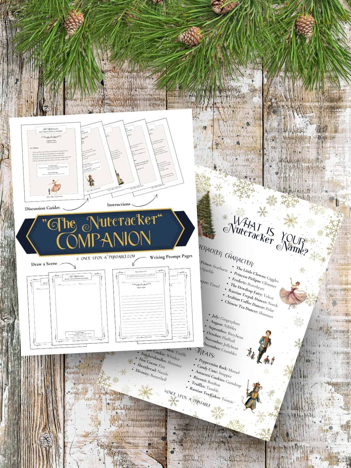 Nutcracker themed printables with original watercolor graphics laying on a wooden surface with garland.