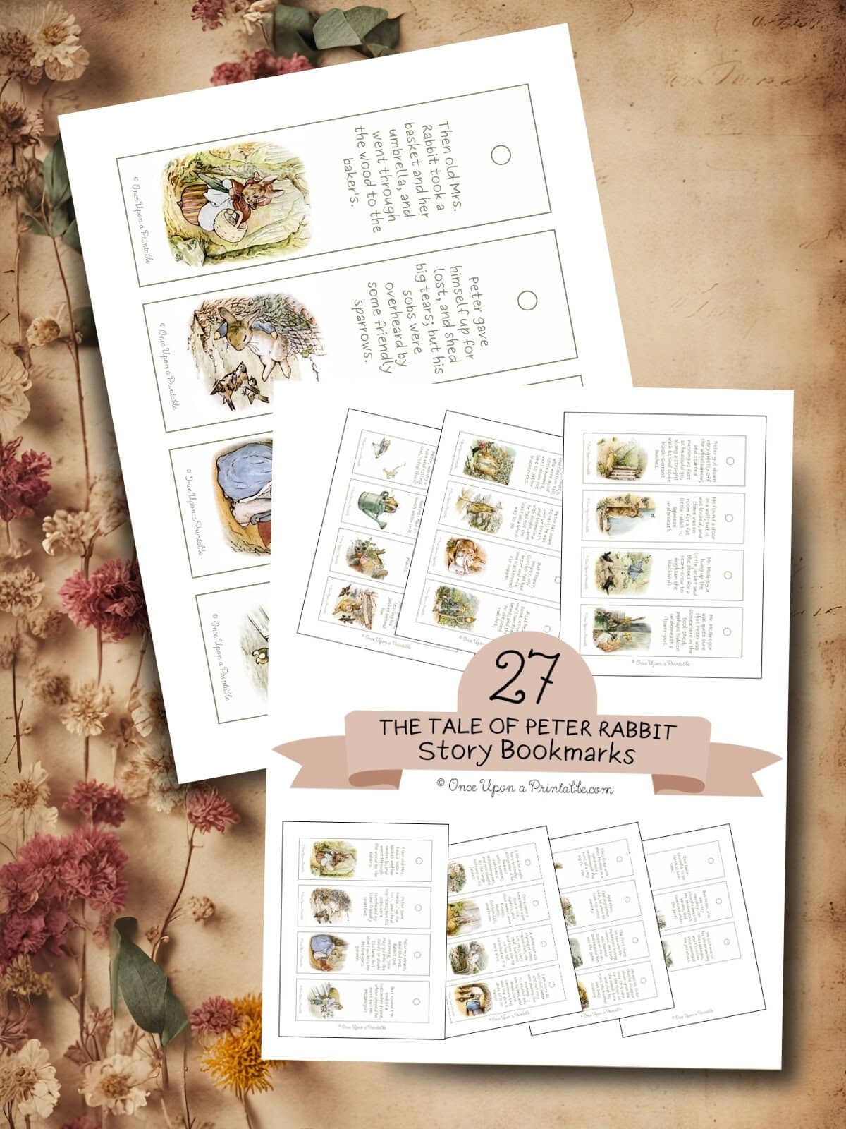 Peter Rabbit vintage story bookmarks laying on a wooden background with dried flowers.