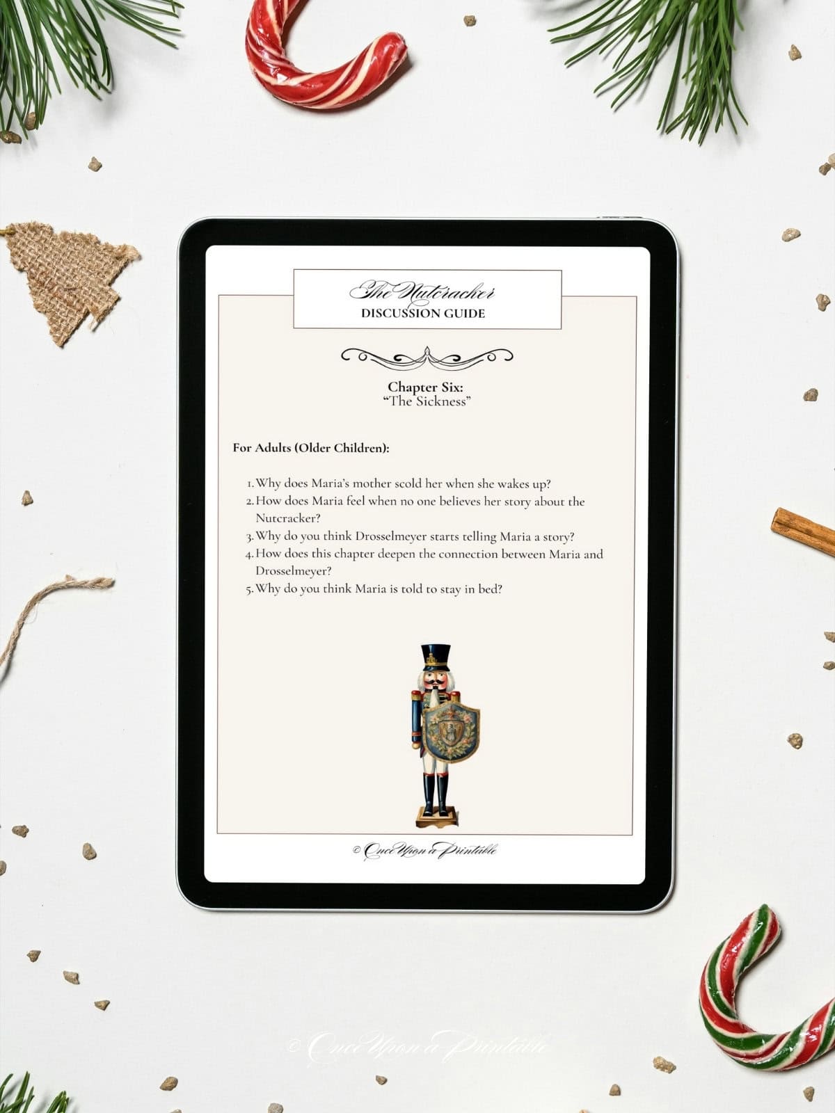 The Nutcracker Discussion guide, chapter six, on a tablet screen laying on a white background with christmas decorations.