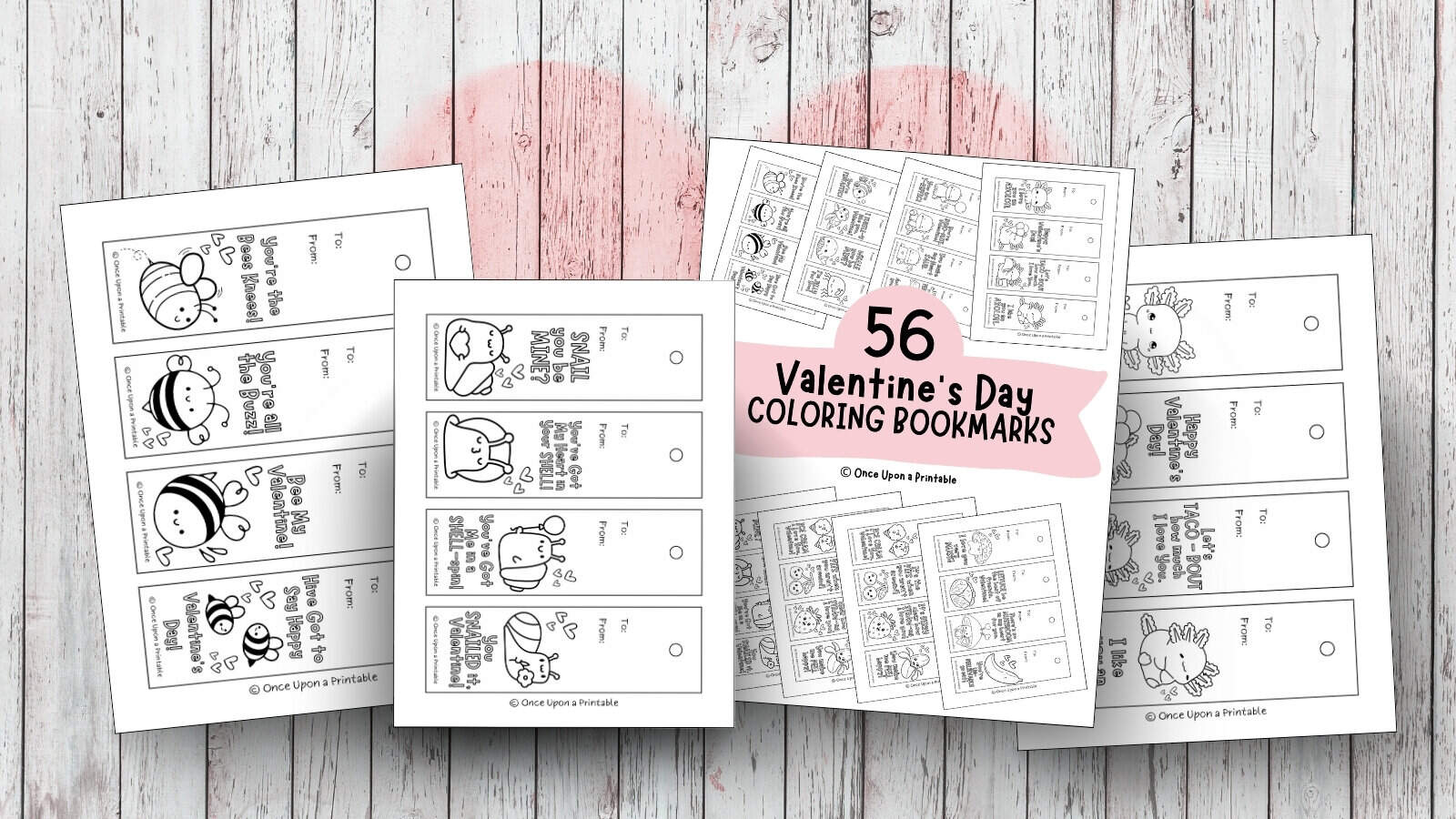 Valentine's Day coloring bookmarks collection fun for classrooms or valentine's day parties alike, laying on a wooden surface with a large pink heart.