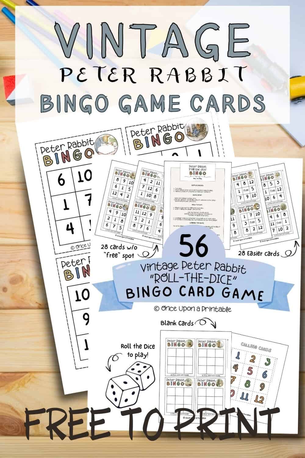 Peter Rabbit illustrated bingo cards laying on a wooden table with coloring pencils and crayons.