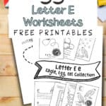 Letter E eagle egg and eel worksheets laying on a wooden table with coloring pencils.