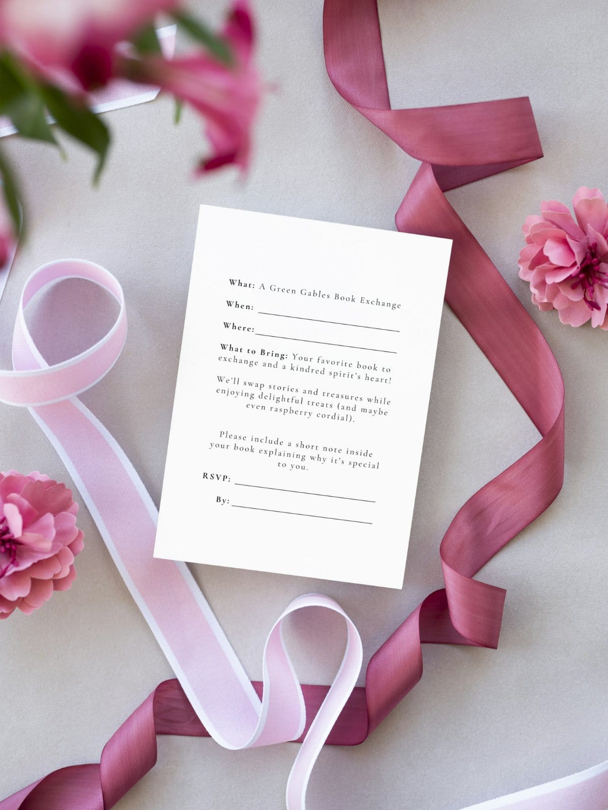 Anne Shirley Book Exchange invitation, the inside, laying on a table with pink ribbons.