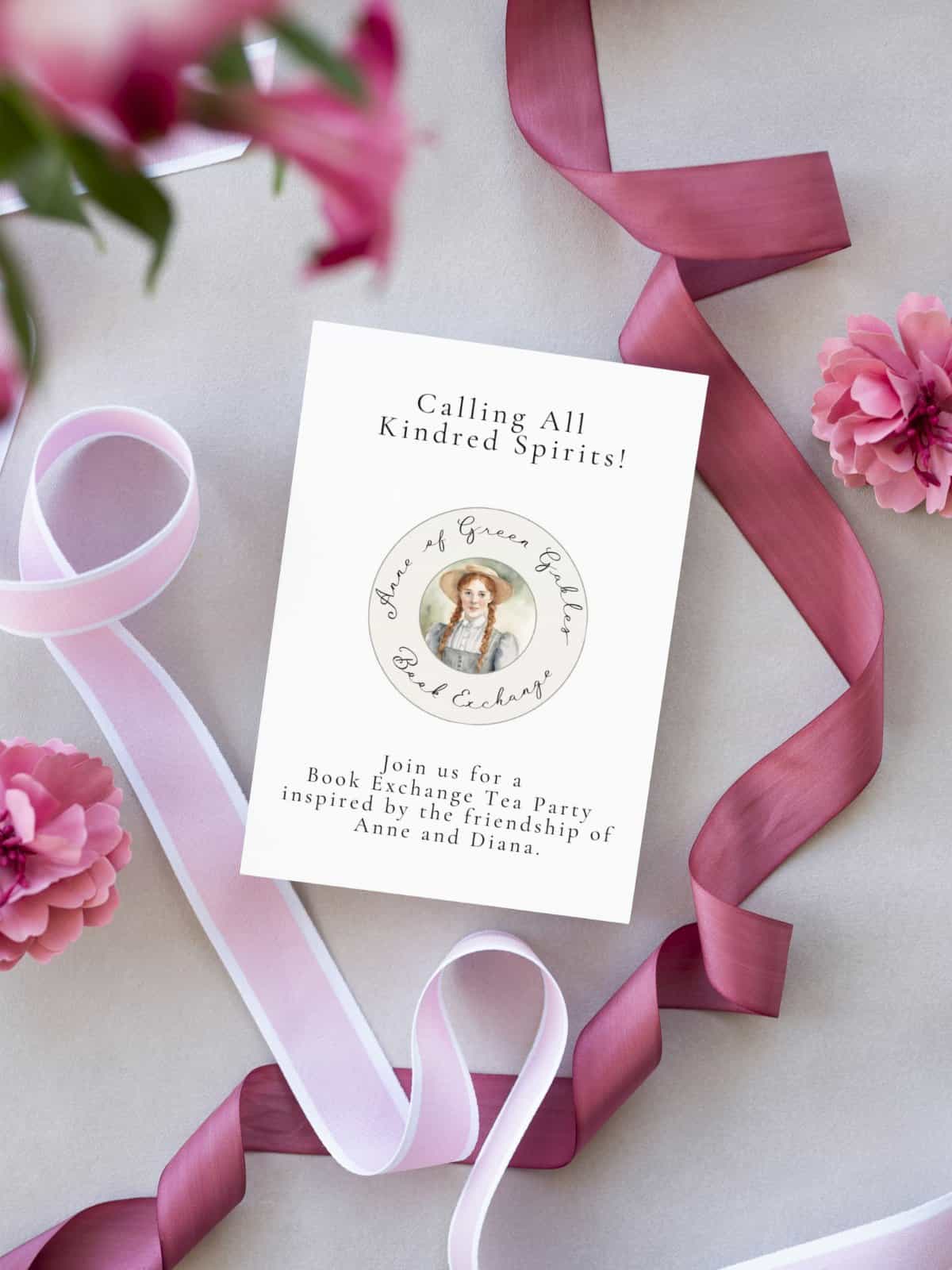 Anne Shirley Book Exchange invitation, the front side, laying on a table with pink ribbons.