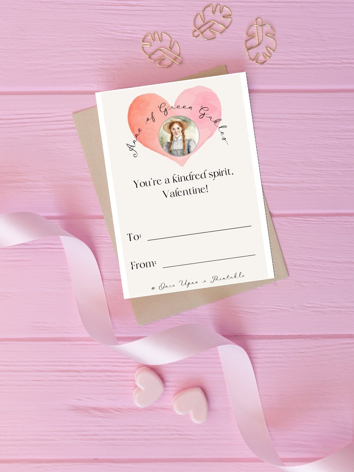 Anne Shirley kindred spirit valentine's day card laying on a brown envelope with a light pink ribbon curling.