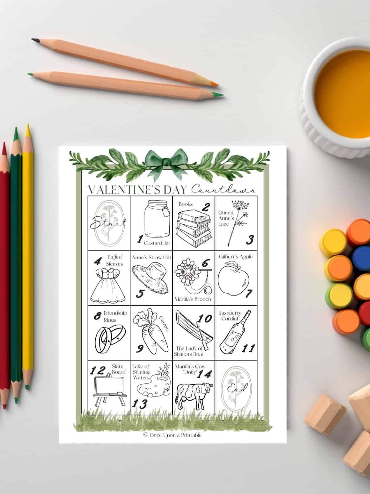 Anne of Green Gables Coloring Calendar laying on a white table with coloring pencils or paints.