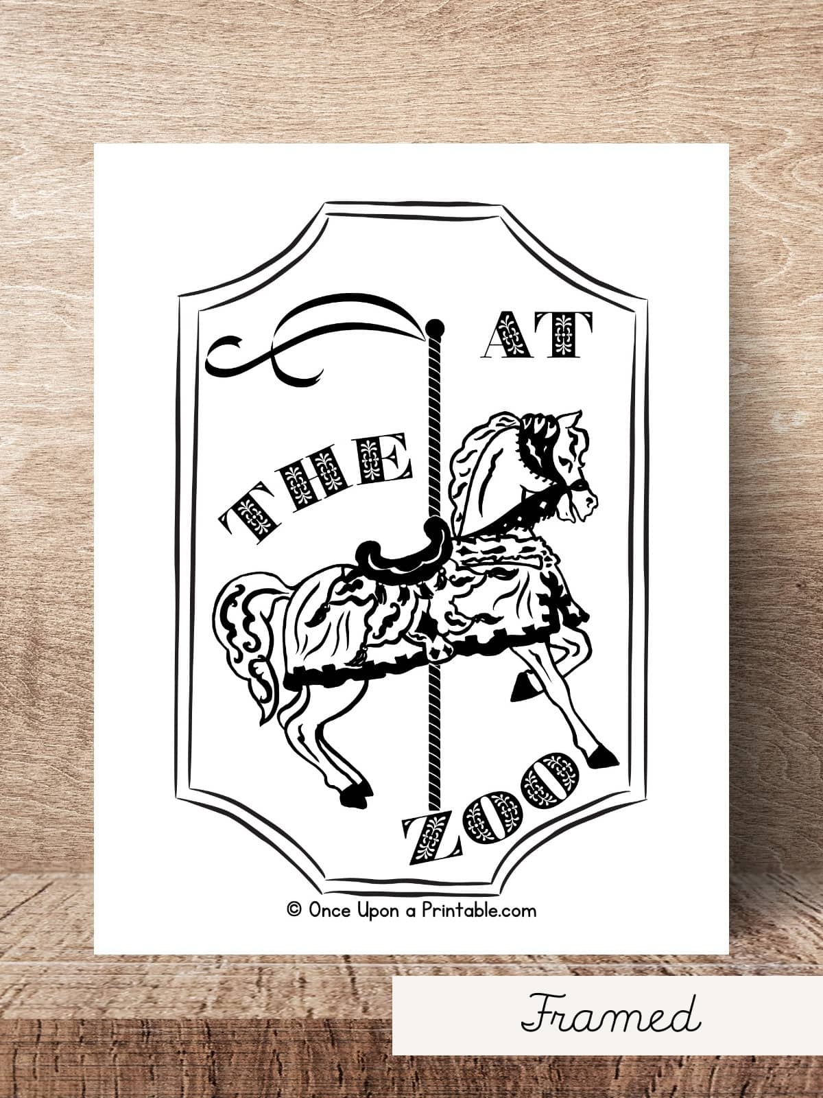 At the Zoo coloring page framed version laying on a wooden table top.