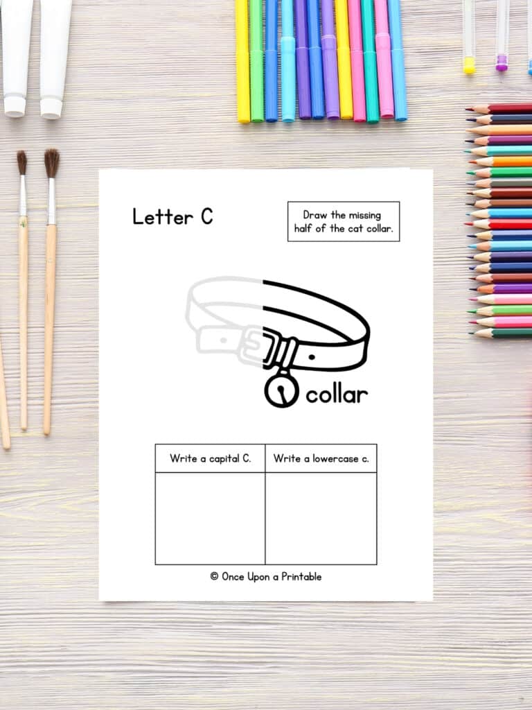 Cat collar letter C activity worksheets laying on a table with coloring pencils. 