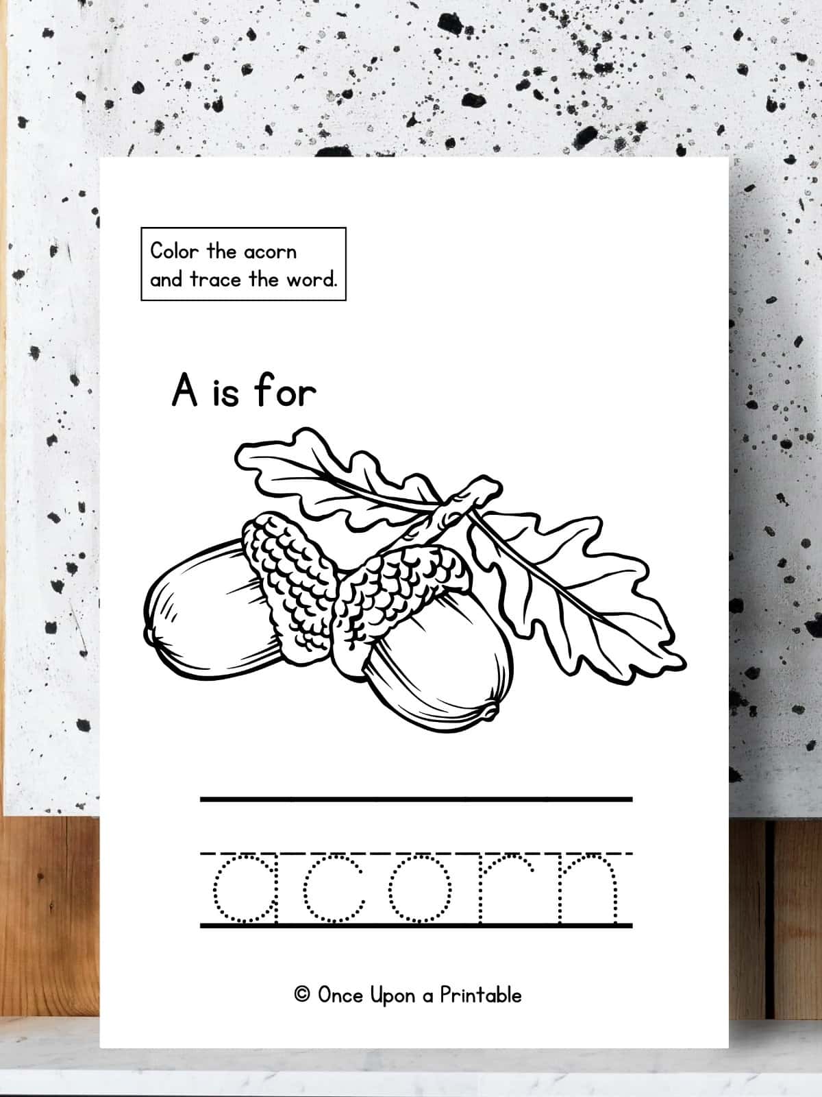 Color and trace the word Acorn printable page.