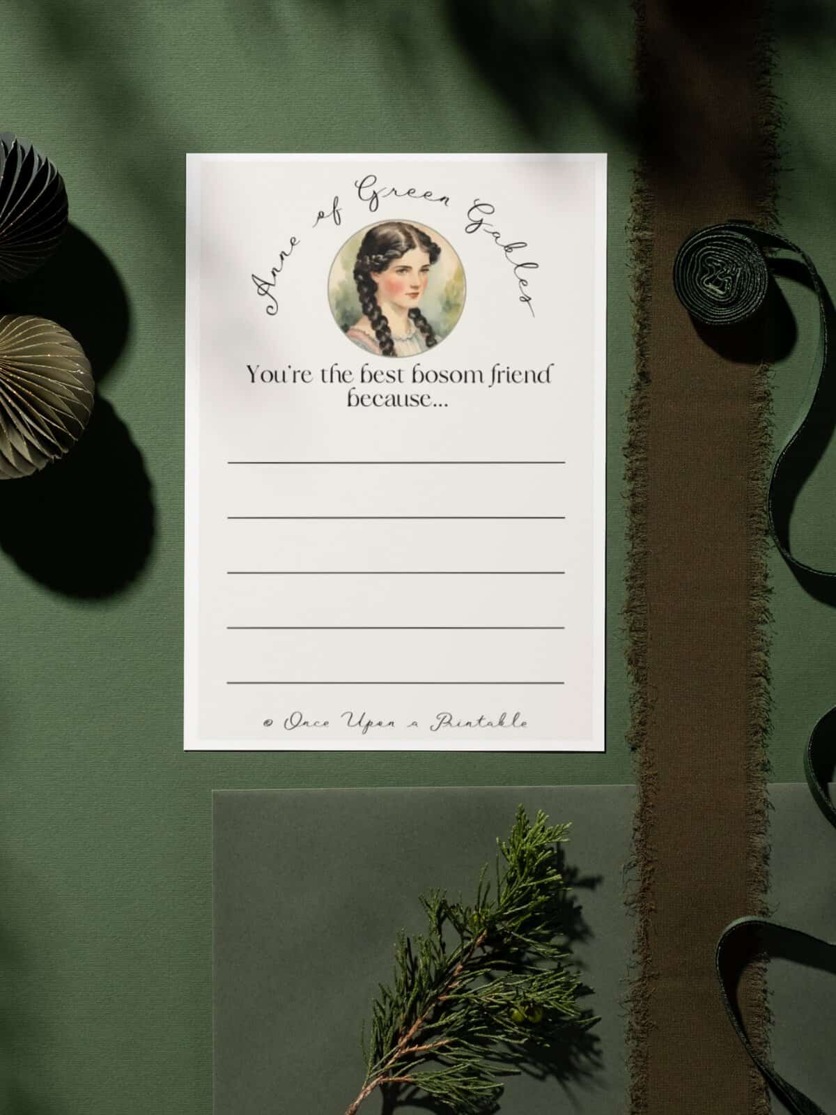 Diana Barry friendship card laying on a dark green background with ribbon.