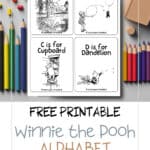 Alphabet flashcards featuring winnie the pooh illustrations laying on a table with coloring pencils.