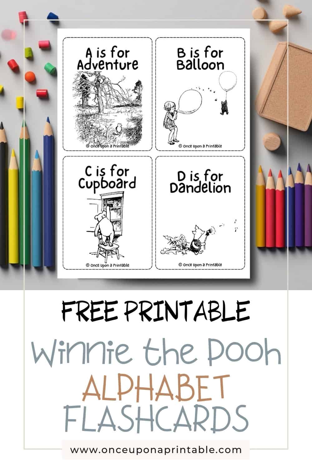 Alphabet flashcards featuring winnie the pooh illustrations laying on a table with coloring pencils.