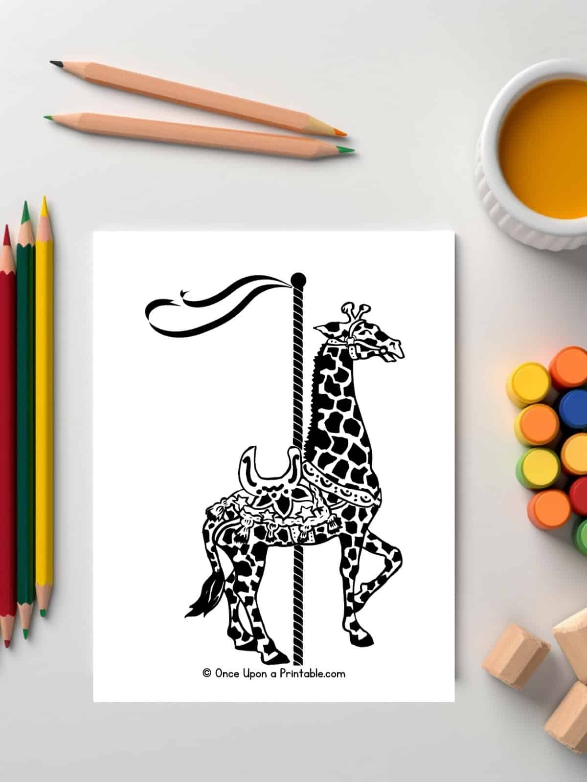 Giraffe zoo animal carousel coloring page laying on a table with coloring pencils.