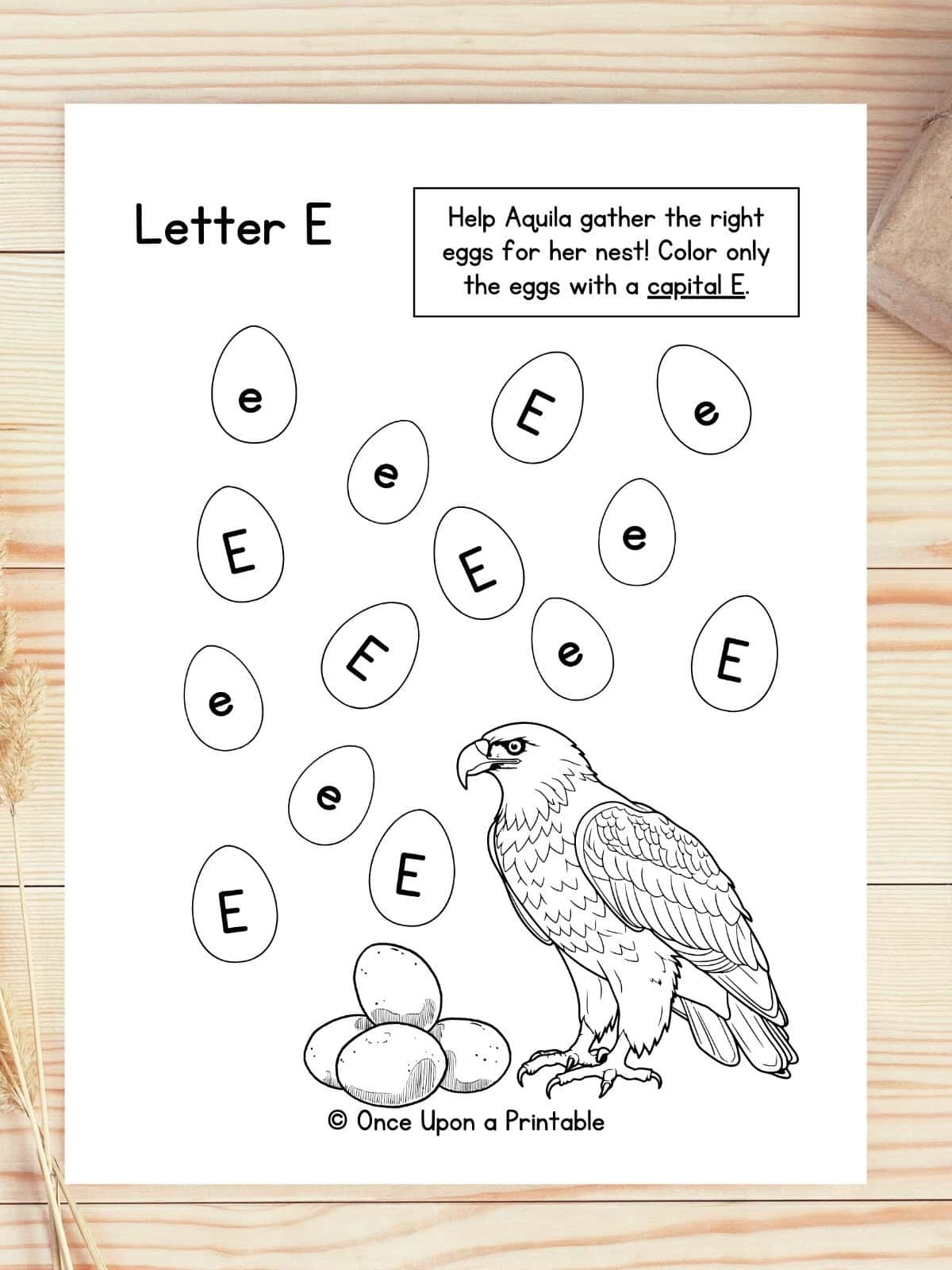 Letter E Eagle, egg capital and lowercase e game laying on a wooden table.