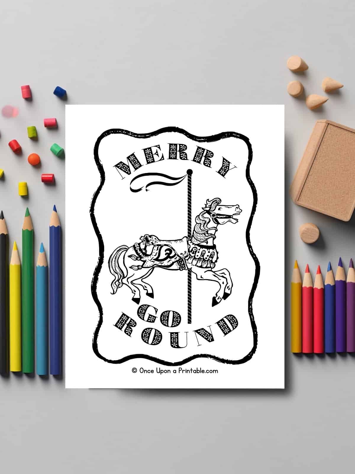 Merry go round horse coloring page laying on a table with coloring pencils.