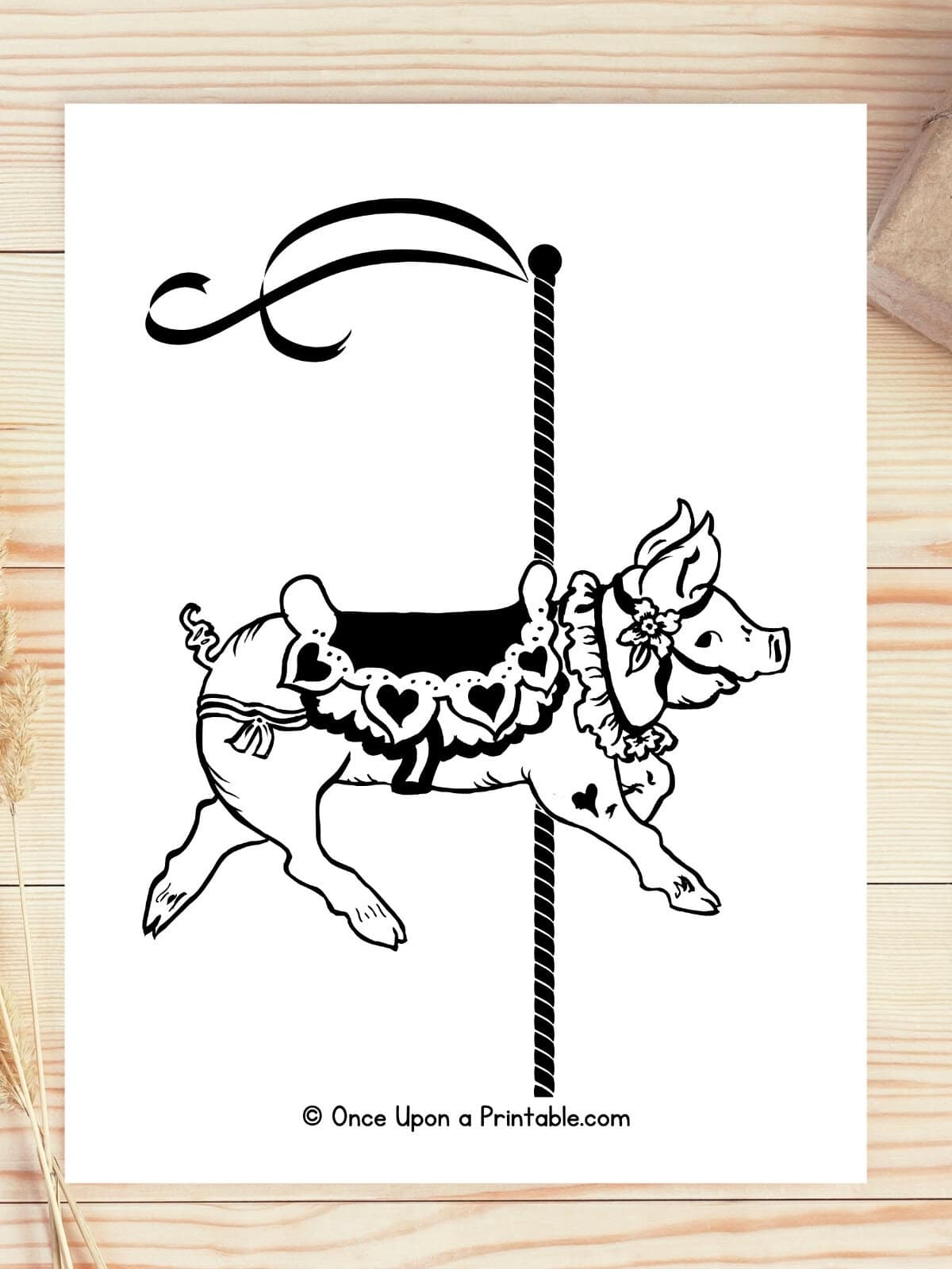 Piggy zoo animal carousel coloring page laying on a wooden surface.