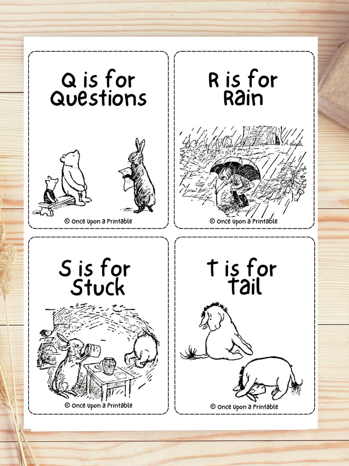 Winnie the Pooh classic illustrated ABC flashcards laying on a wooden table.