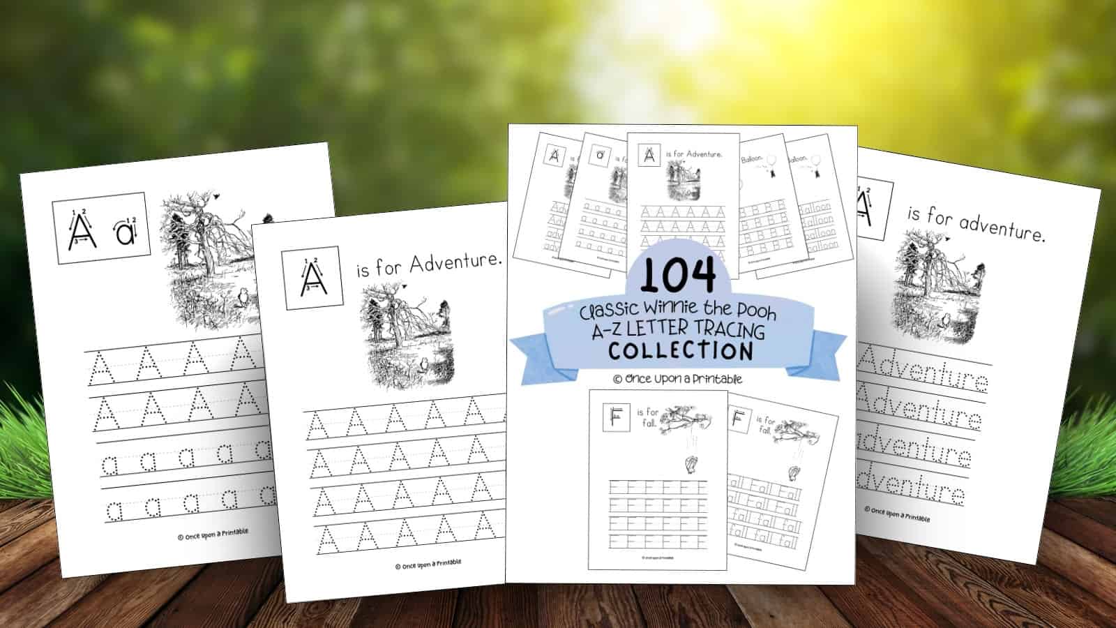 Classic Winnie the pooh letter and word tracing pages laying on a wooden picnic table outside in the sun.