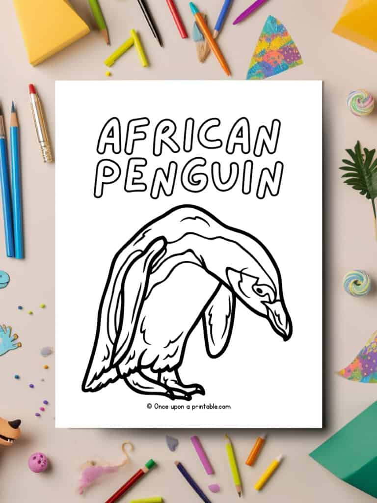 A is for African Penguin animal coloring page laying on a table with art supplies all over.