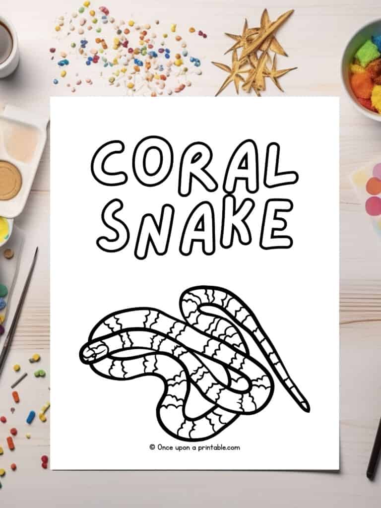 C is for Coral snake coloring page laying on a table.