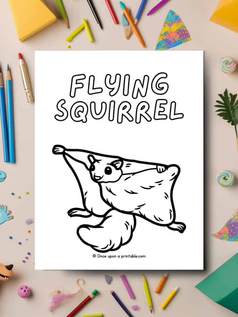 F is for Flying Squirrel animal coloring page laying on a table with coloring supplies all over. 