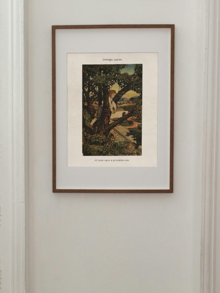 Full page illustration in color by Jessie willcox smith "foreign lands" framed and displayed on the wall.