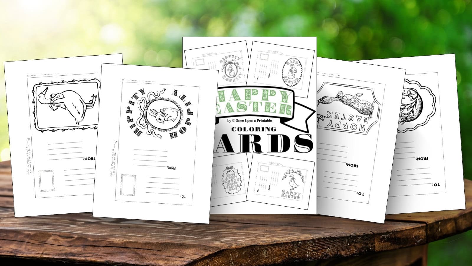 Happy Easter coloring cards for kids and adults laying on a wooden table.