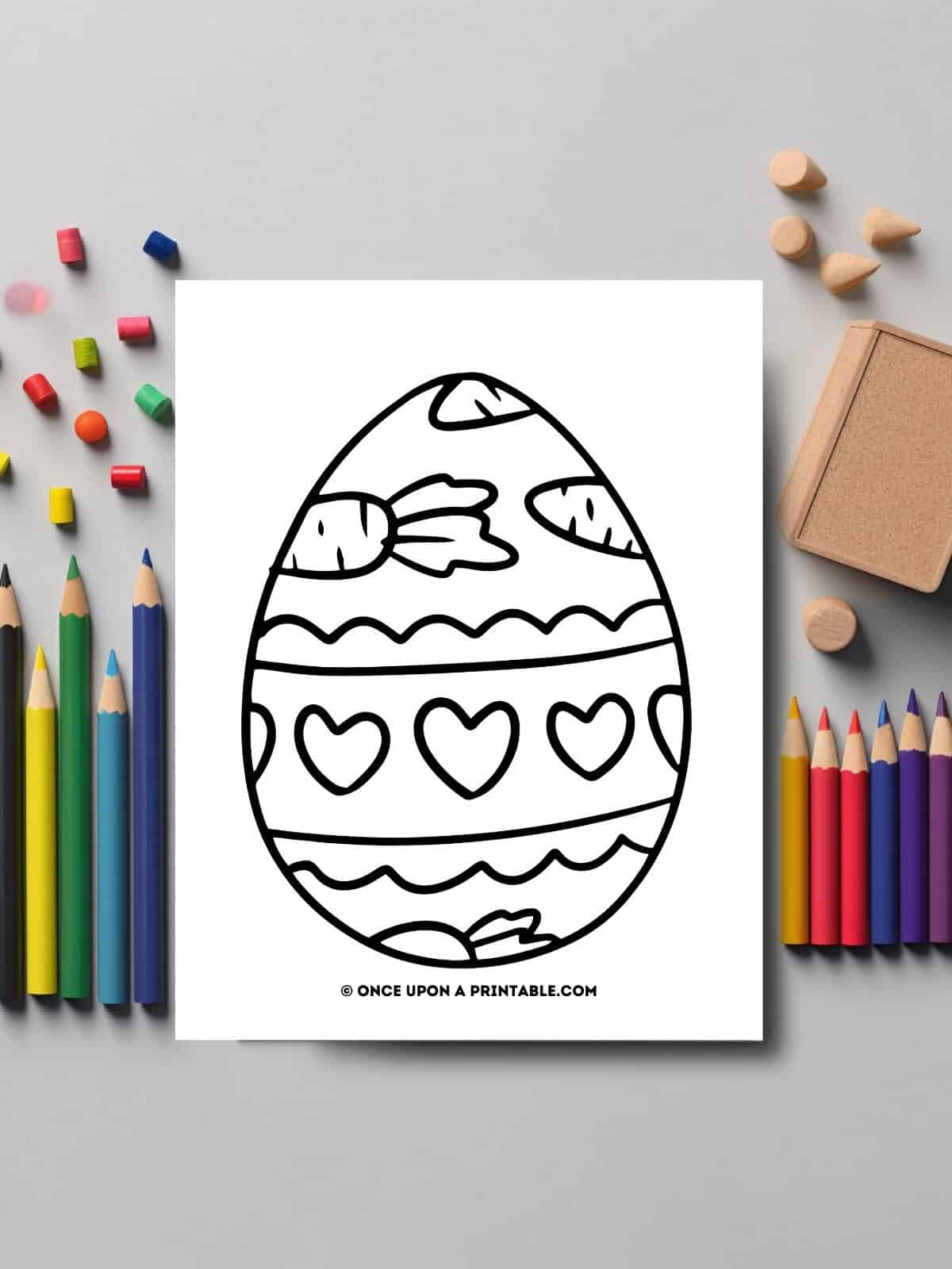 Little kids Easter egg coloring page laying on a table.
