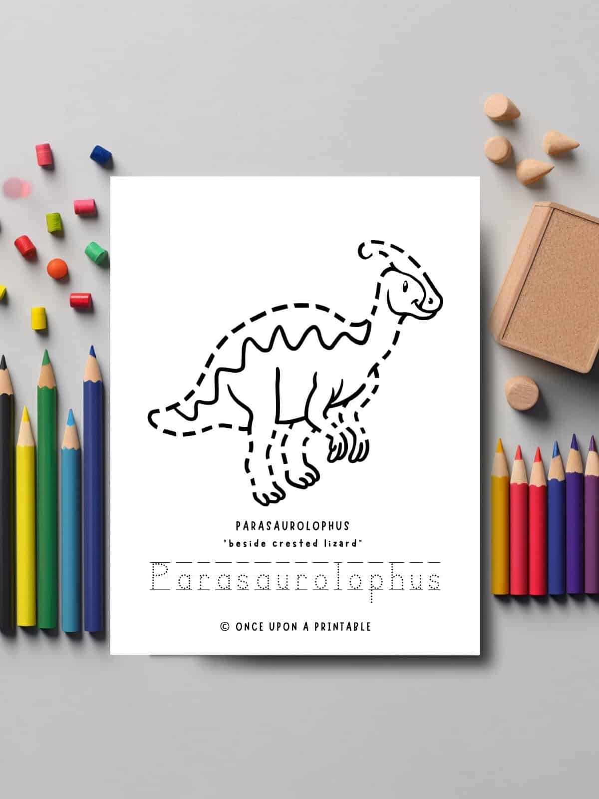 Parasaurolophus dinosaur tracing and coloring page laying on a table with coloring pencils. 
