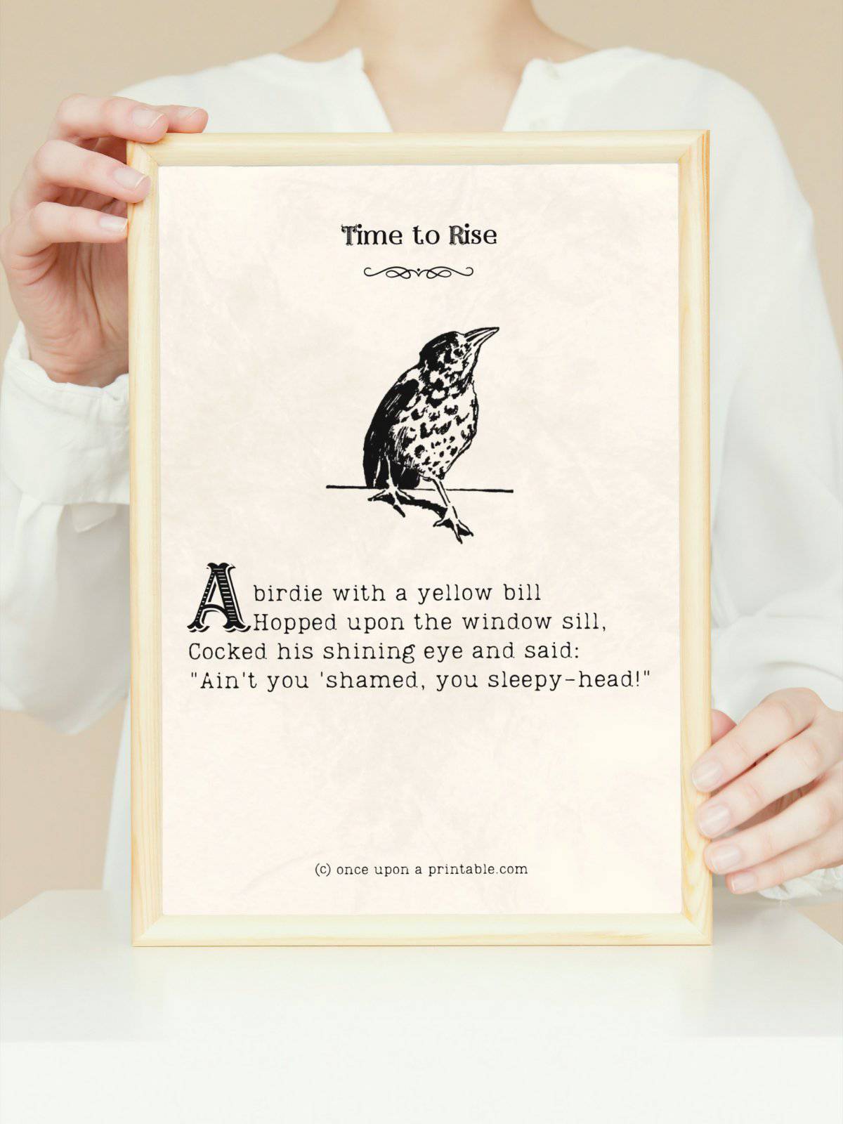 Time to Rise a poem from "a child's garden of verses" with illustration of a little bird, framed and held by a woman.