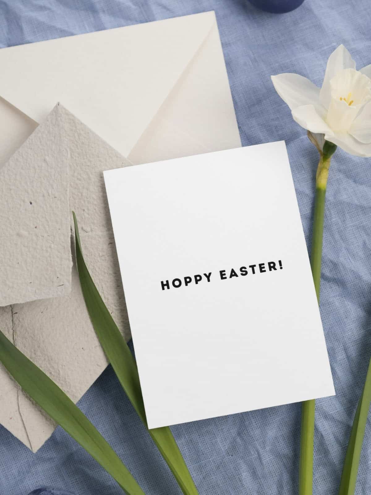 "Hoppy Easter' sentiments on the inside of a card laying on a daffodil.