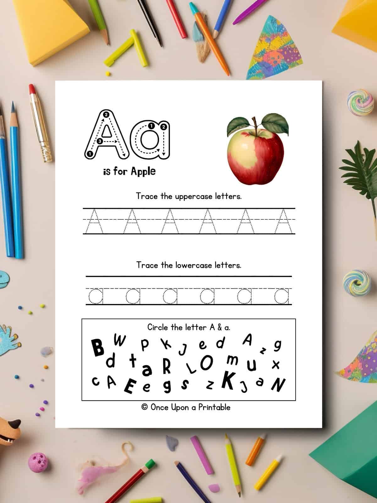 A tracing worksheet page with other activities, laying on a table with art supplies. 