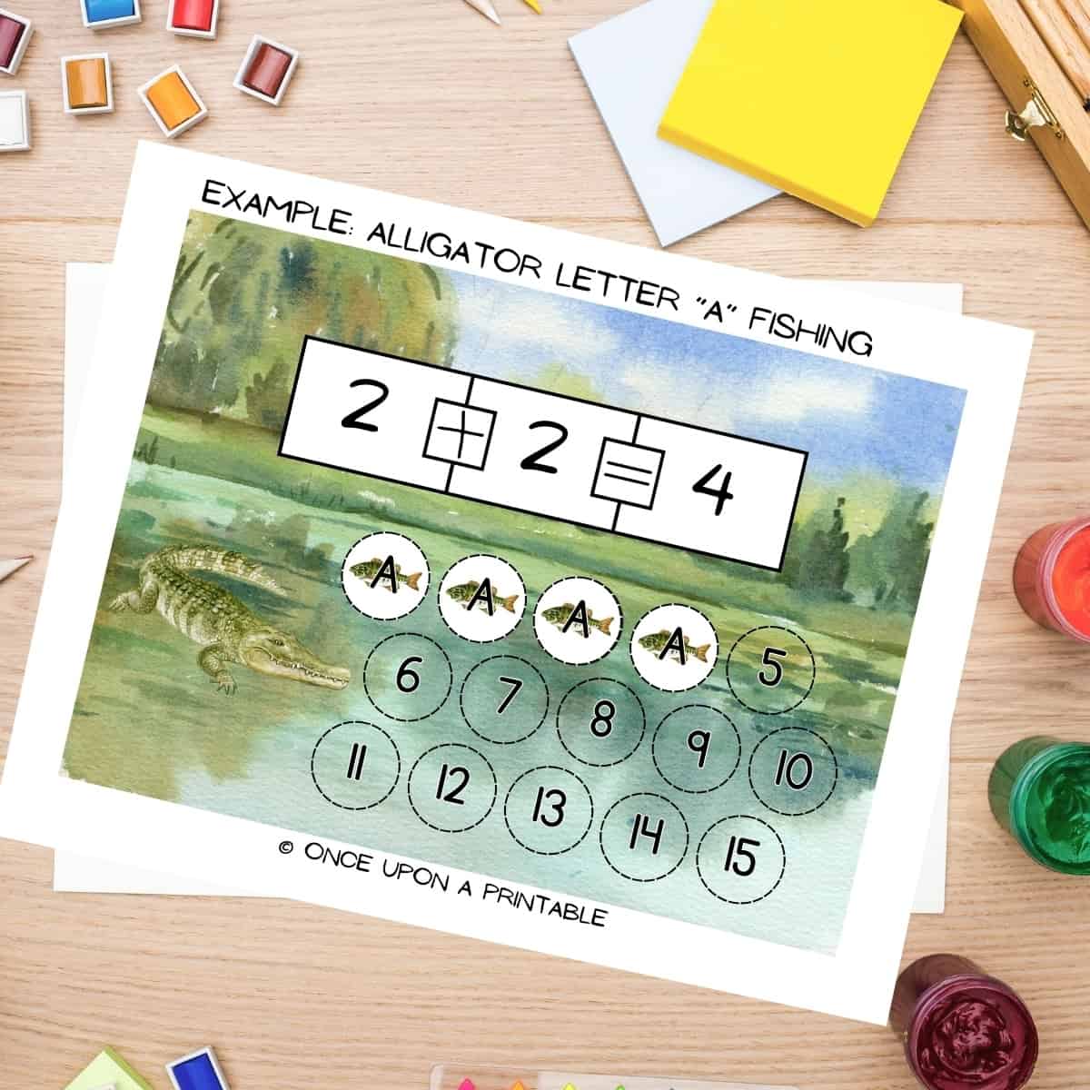 Letter A Alligator letter and number games for kids laying on a table with art supplies.