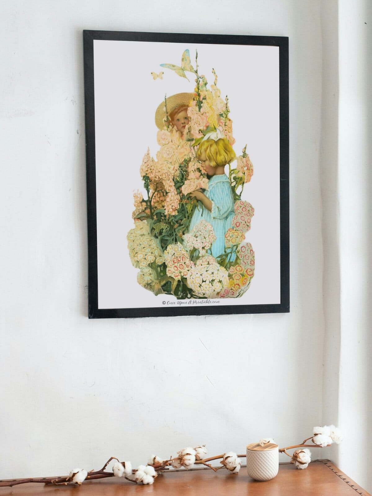Children in nature by Sarah Stilwell Weber framed on a wall. 