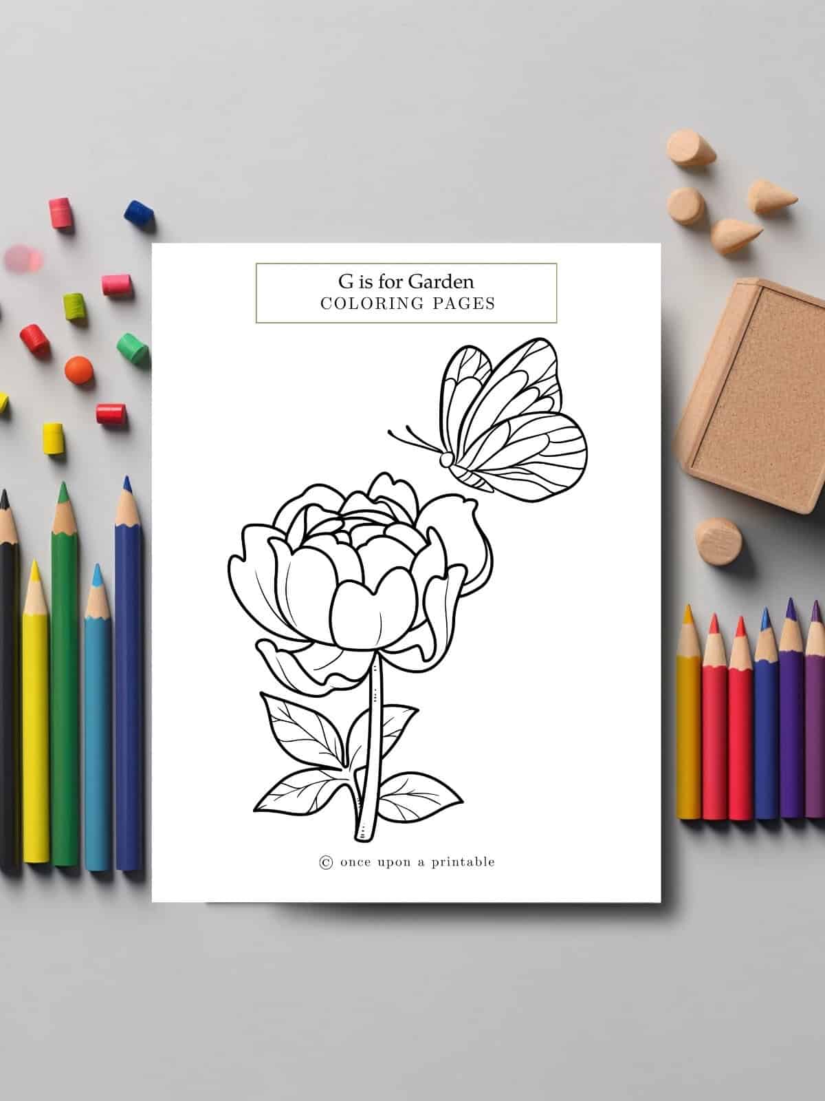 G is for garden coloring page flower and butterfly laying with art supplies.