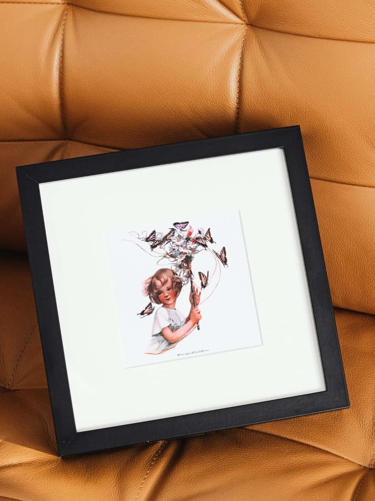 Girl with butterflies, spring art print by Sarah Stilwell Weber in a square frame. 