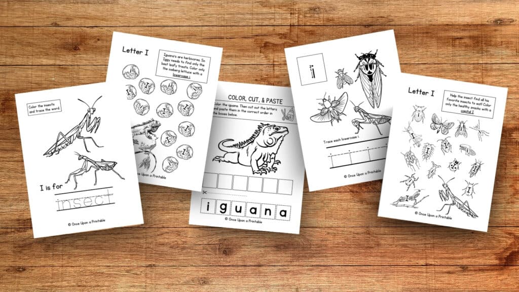 Letter I unit study worksheets with iguana and insects laying on a wooden table. 