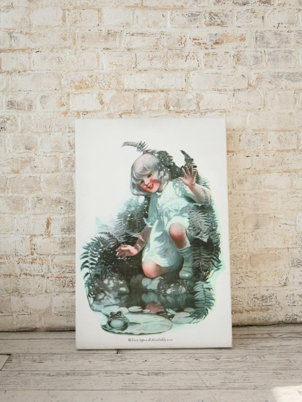 Little girl catching a frog, Sarah Stilwell Weber on canvas leaning up against a wall. 