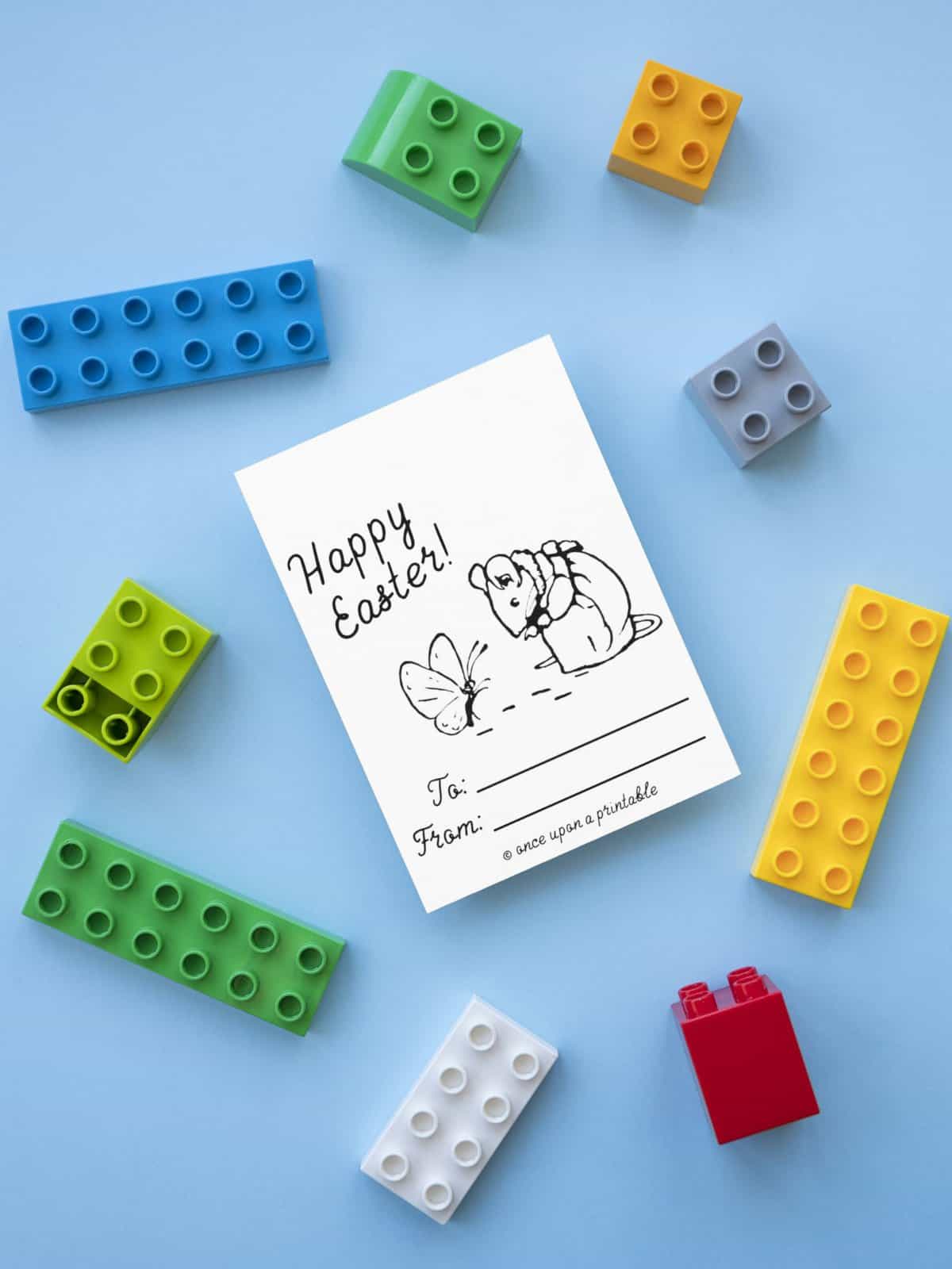 Mrs Tittlemouse Easter coloring card laying on a blue background with bricks. 