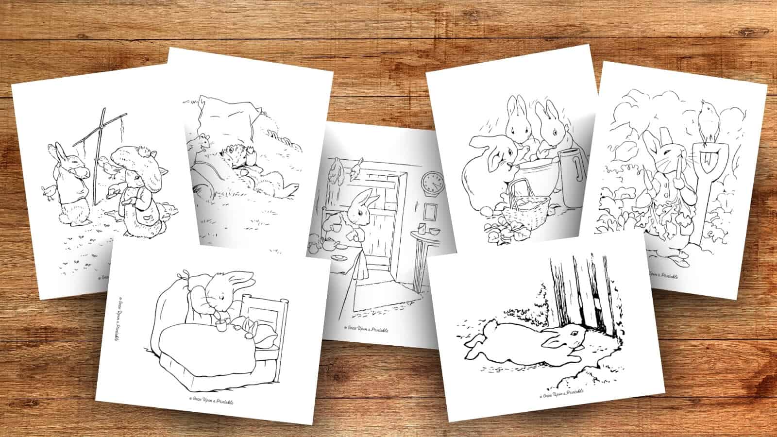 Peter Rabbit and friends coloring pages laying on a wooden table. 