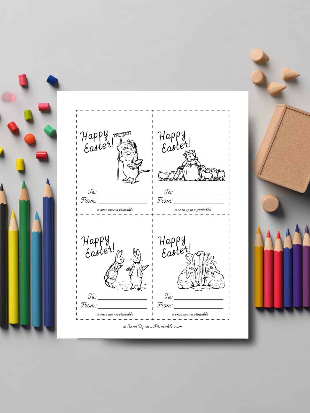Peter rabbit and friends Easter coloring cards laying with coloring pencils.