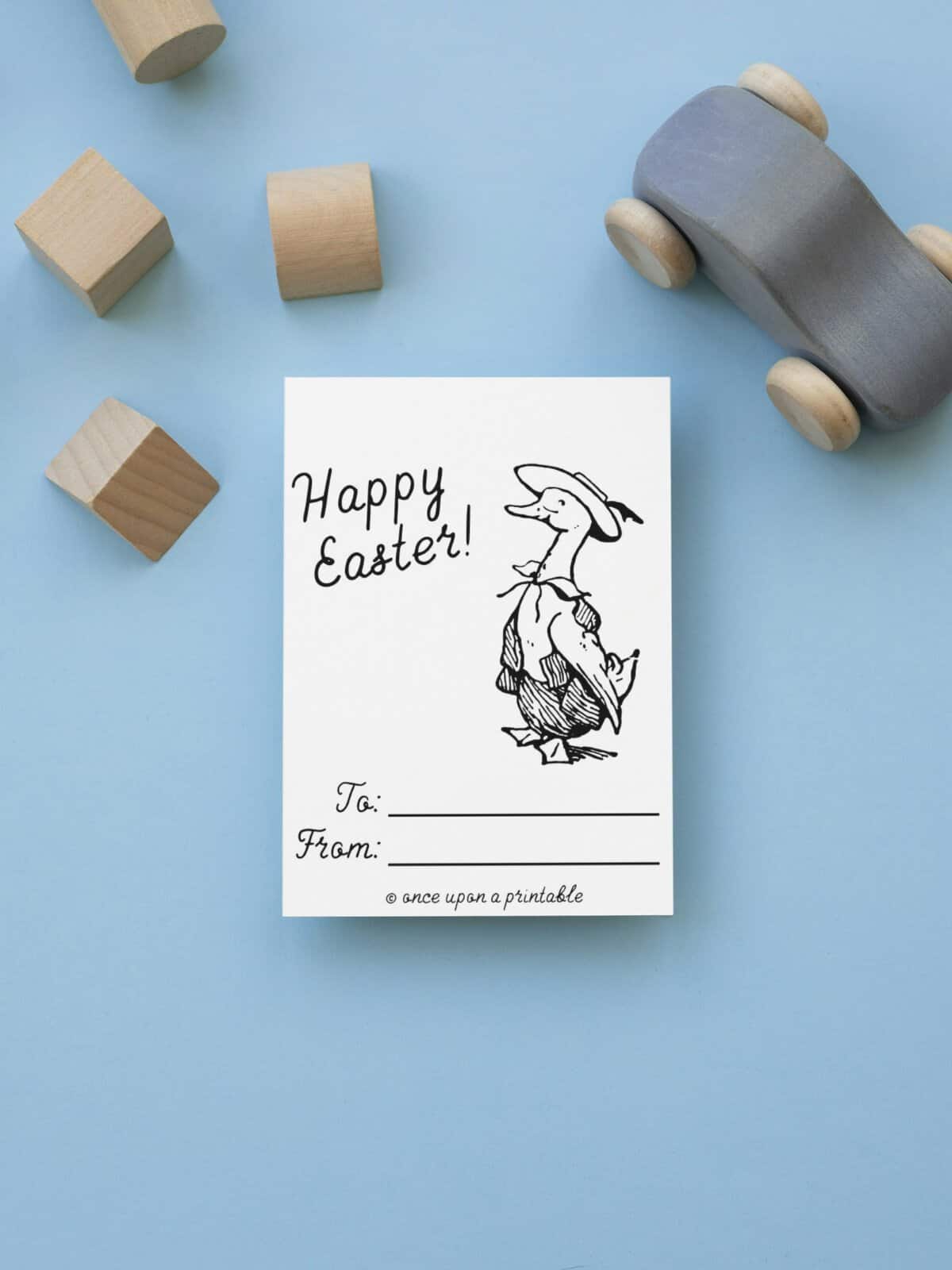 Puddleduck Happy Easter coloring card on a blue background.